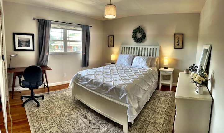 Large bedroom with Queen size green tea cooling gel memory foam hybrid mattress, large closet, dedicated working space, standing mirror and black out curtains.

Table lamps with USB charging port &  power outlet for charging devices.