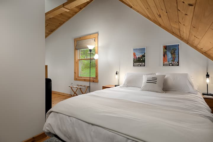 Master bedroom with a queen bed, office area and en suite bathroom. 