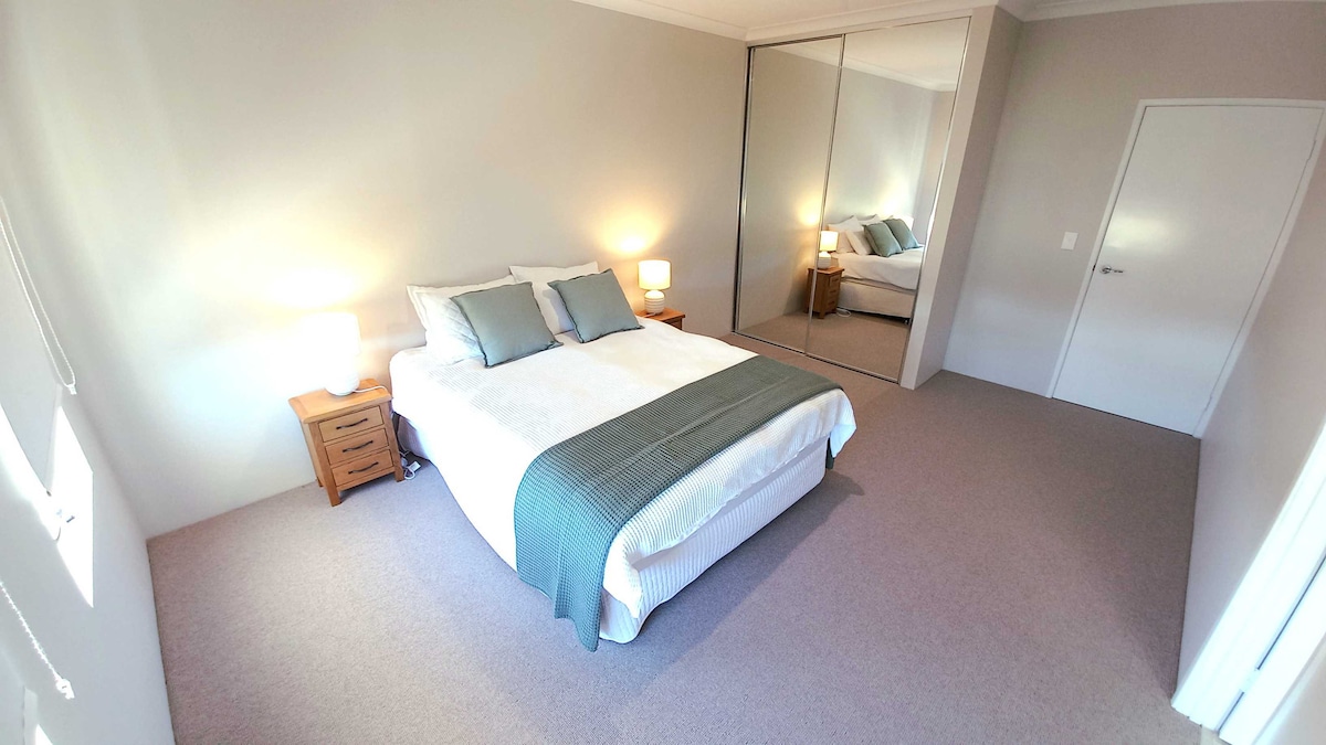 Dormitorio azul; el baño privado está fuera de servicio a la derecha.