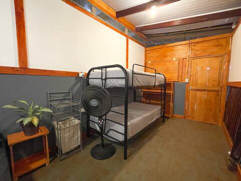 Single bed in shared AC room with outdoor kitchen