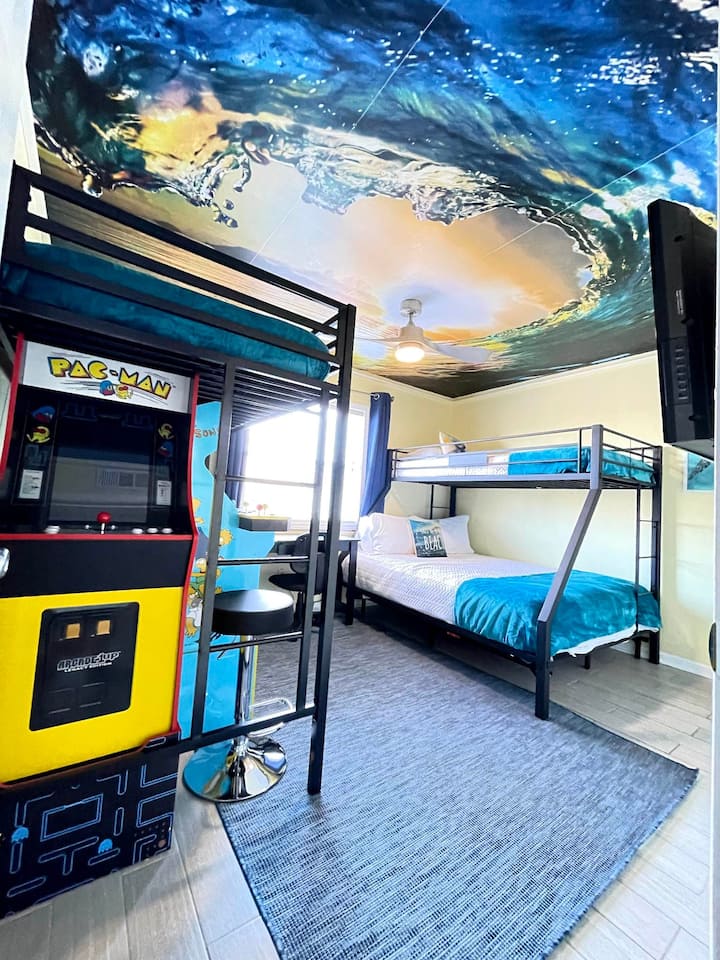 Guest Bedroom - XL Twin over Queen Bunk Bed, Twin Loft Bed,  Pac Man Arcade (12 games), Simpson Arcade, Desk w/Chair, Room Darkening Curtains, Ceiling Fan, Walk-in Closet w/Drawers & Shelves, TV w/Roku Stick, Unique & Mesmerizing Ceiling Mural