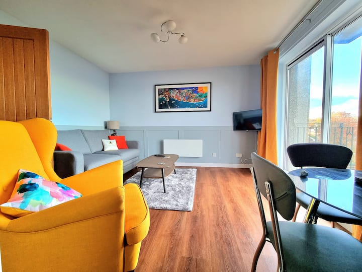 Our lounge area with colourful art from a local artist portraying most of the key landmarks and pubs from around the town.