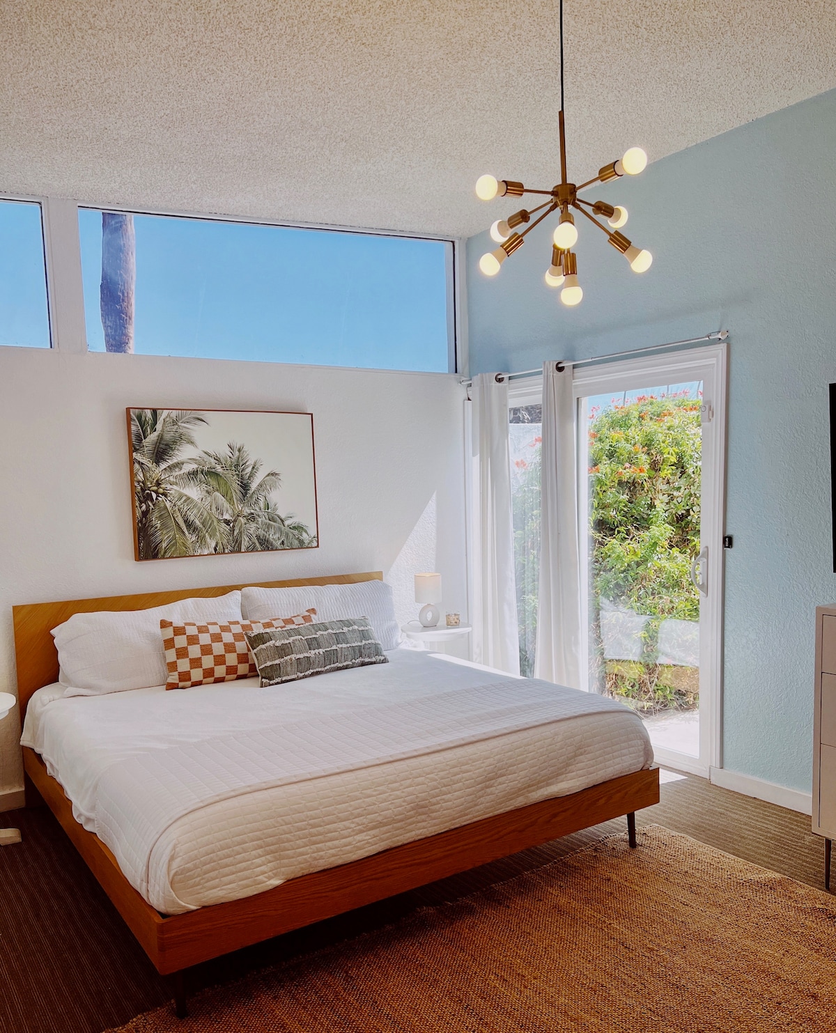 Primary bedroom with en suite bathroom, private patio and 60 inch flat screen. 