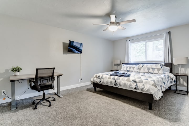 Master bedroom with king memory foam mattress, desk and smart TV