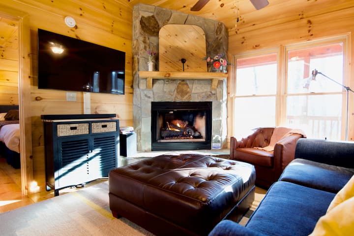 Our living room is meant for lounging, with a huge leather ottoman for spreading out, or for settling up board games with your friends. Gas logs make the mood in the winter, and use the 100mb connection to stream on the 4k 55" tv