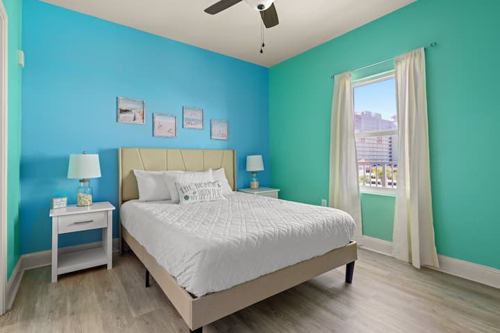 De hoofdslaapkamer heeft veel ruimte. Het grote raam laat veel licht binnen en de slaapkamer kijkt uit op een zwembaddek. Geniet 's nachts van een boek met een van de lampen op de nachttafels.