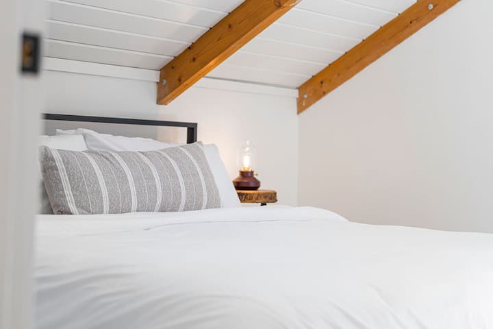 Upstairs primary suite features its own private entrance, USB and USB-C bedside outlets and an en-suite bathroom.