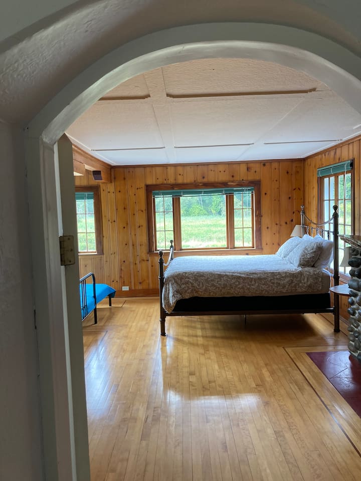 Master bedroom was the old living room so it has a lot of character.  River rock fireplace an original floors and ceiling. 
