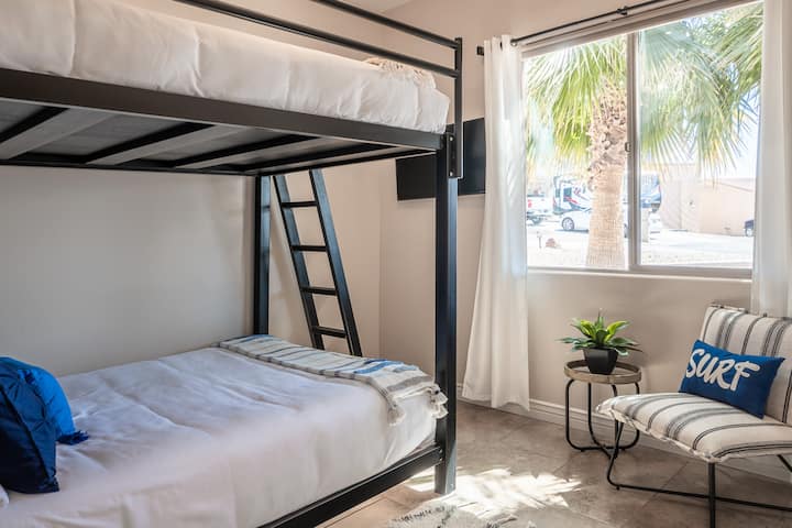 Queen over Queen industrial strength bunk beds. For the kid in all of us! There is a USB outlet on the left side of the top bunk for charging your phones and a power outlet on the bedside table.