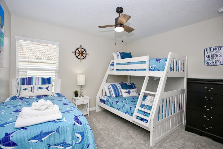 The first of two children's room complete with two twins and one full size bed.