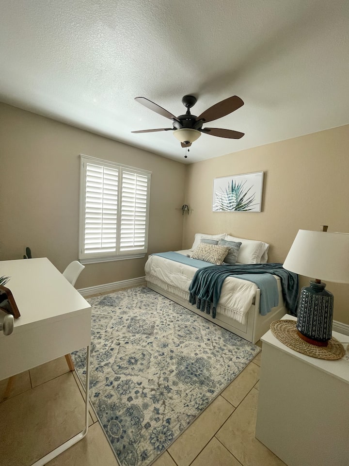 Introducing the Blue Room: This downstairs room has a twin bed, convertible to king, work desk, calming blue decor, and USB nightstand. Ideal for 2 guests.