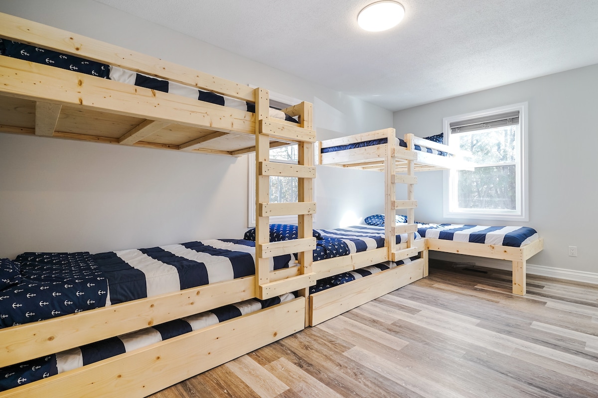 Ultimate bunk room with 7 beds—perfect for sleepovers, family getaways, and group lodging.
