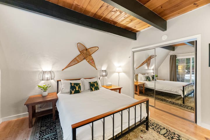 The downstairs bedroom is located right by the kitchen and is the closest to the bathroom. It has a queen size bed, a full size closet, plenty of lighting, a beautiful view of the back property, and more.
