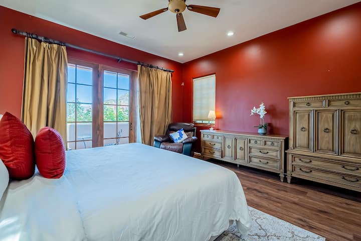 The Primary Bedroom offers a deluxe king-size bed and a 2-sided gas fireplace. Walk out the French door to the amazing outdoor covered porch, sit back, and enjoy the red rocks.  A spacious walk in closet completes the space.