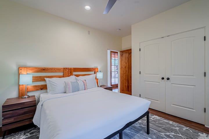 This bedroom includes a comfortable king-size bed and a full-size closet, providing both relaxation and ample storage space.