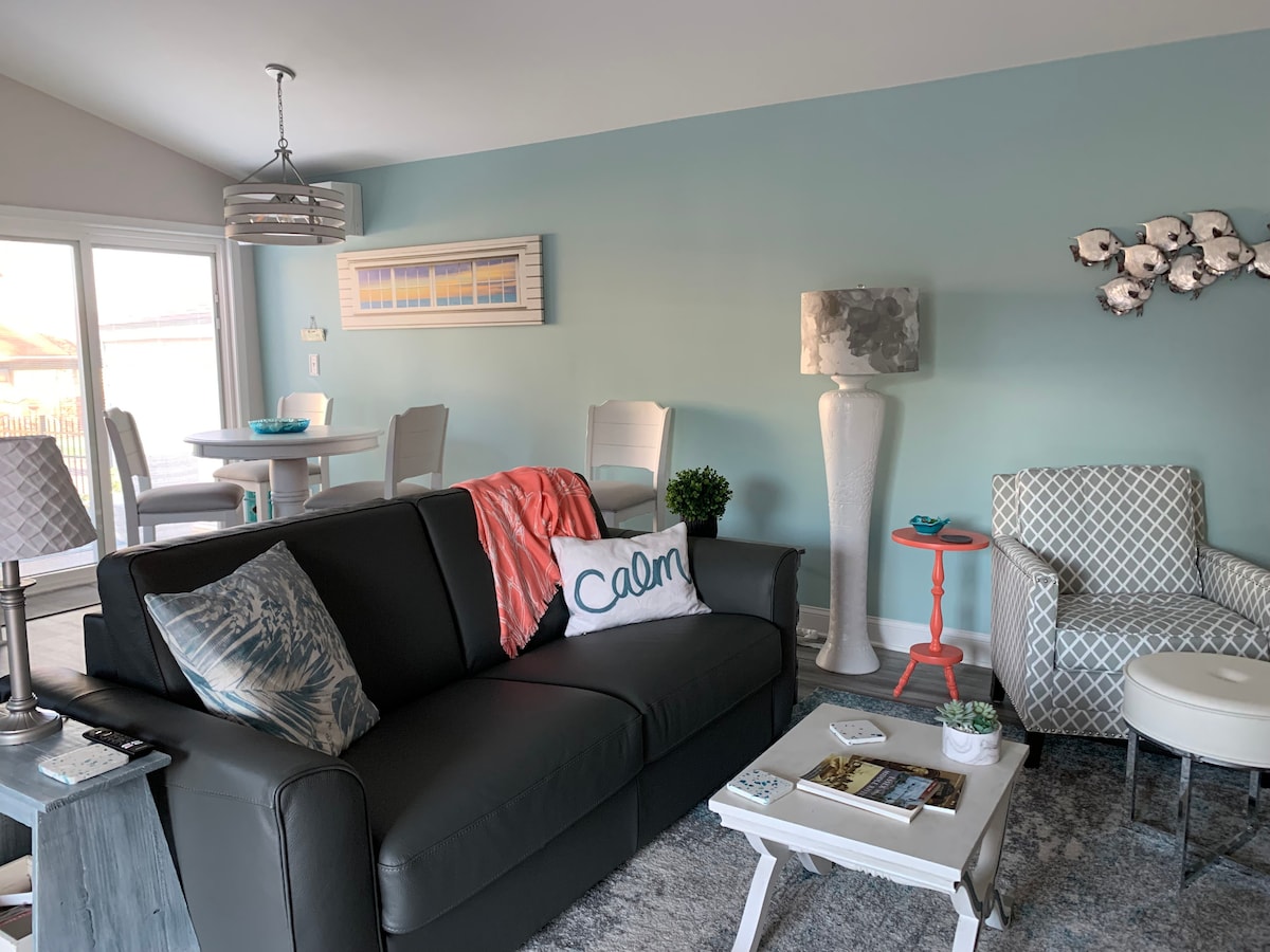 Enter The Little House and step into the Great Room. The gray leather sleeper sofa can easily be converted into a very comfortable queen bed. The sliding door behind the counter-height round table exits to an attached deck and brick patio.