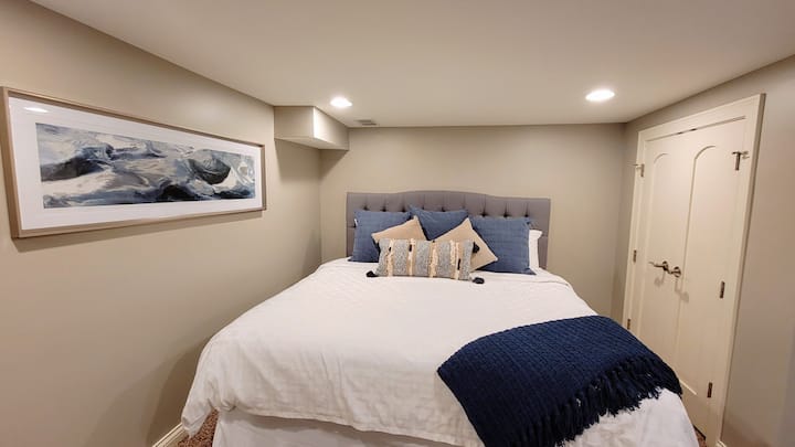 ห้องนอนใหญ่ชั้นล่างพร้อมเตียงคิงไซส์และที่เก็บเสื้อผ้าในตัวในตู้เสื้อผ้า