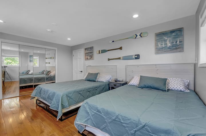 Bedroom 4 - the coastal room. Two queen size beds and a mirrored closet with more storage then you’ll ever need. 