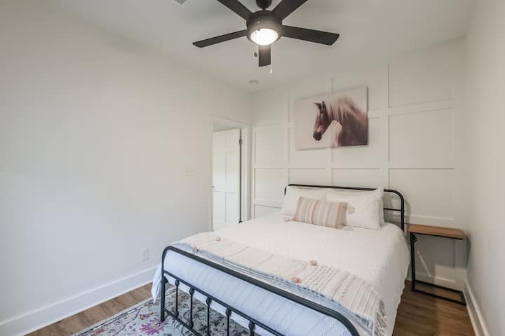 Დედოფლის ზომის საწოლი დასამუხტი სადგურებით ღამის საათებში.