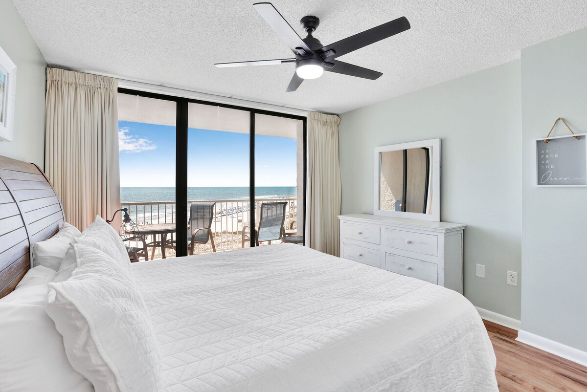 Chumba cha kulala cha Master kina kitanda kikubwa, bafu ya kibinafsi, na ufikiaji wa roshani. 