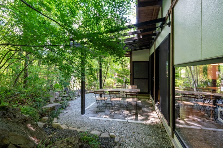 A private rental villa with a large Japanese-style room, a solarium with a grove view, and an outdoor terrace