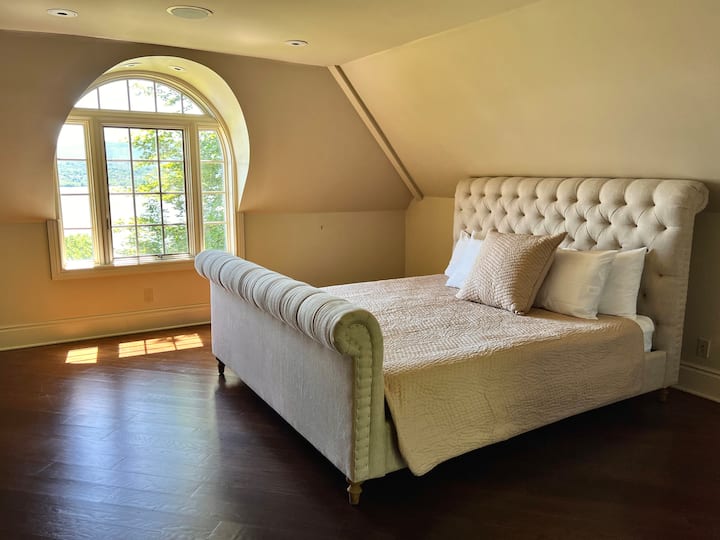 Bedroom #7  Attic bedroom kingsize tufted bed