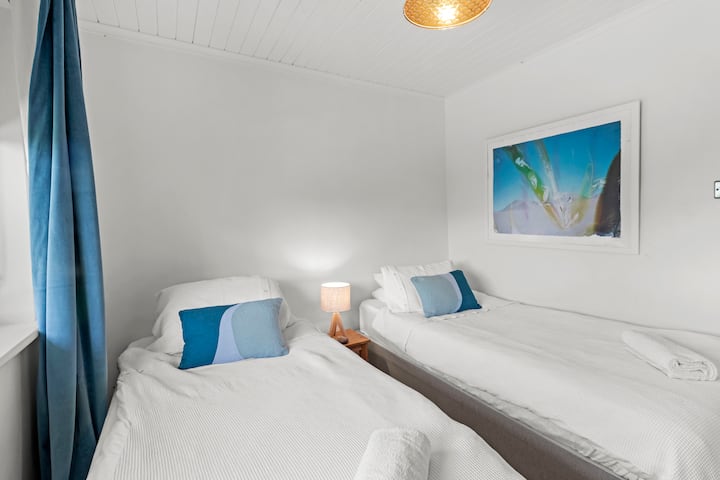 Two single beds in the downstairs bedroom of the house