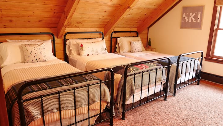 Upstairs hideaway with three cozy twin beds — perfect for kids or the crew.