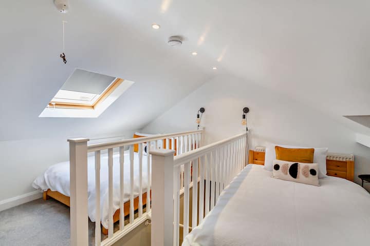 Pitched attic bedroom: 1 double and 1 small double bed adjacent to the balustrades 