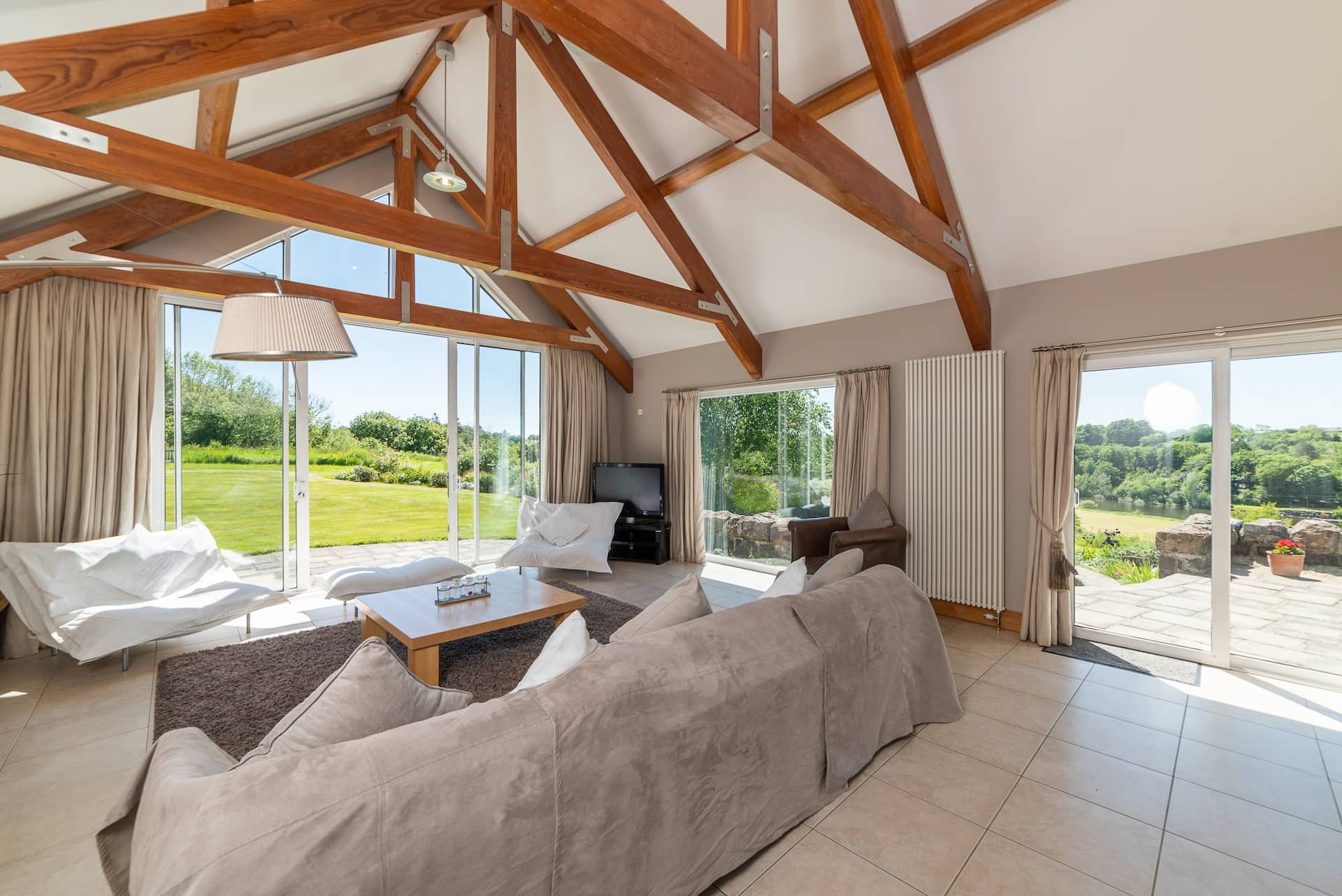 The vaulted living room at Dundarragh Lodge, built around one tall window