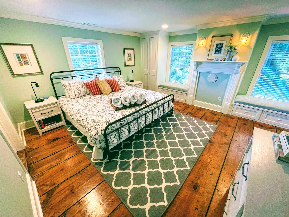 Bedroom 1 includes a KING bed, en-suite bath, privacy shades, dresser, and two wardrobe closets. Other amenities include a 55" smart TV, Google Nest smart speaker, voice-controlled dimmable lighting, and bedside lamps with built in USB charging.