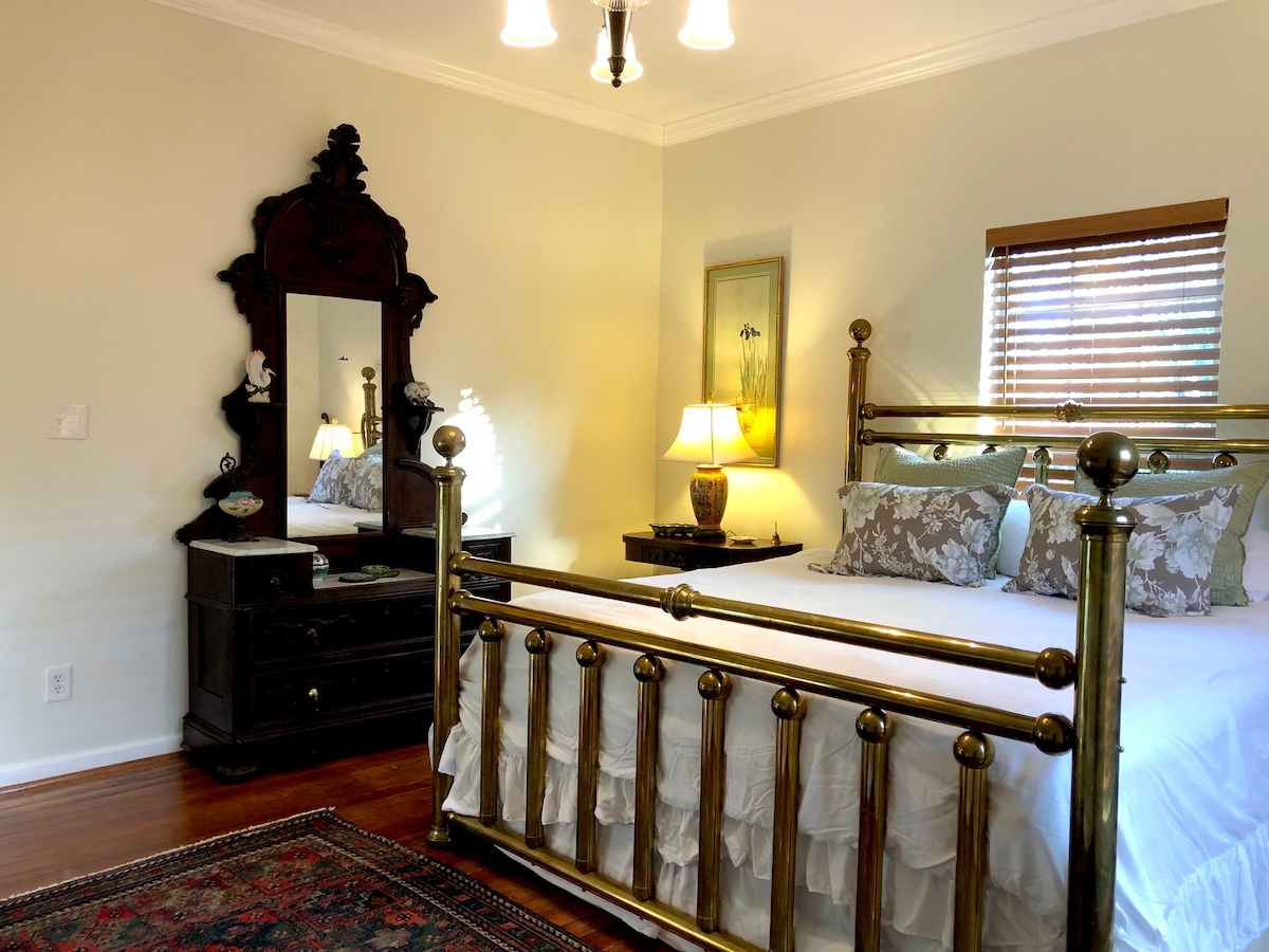 Მთავარი საძინებელი აღჭურვილია კომფორტული მატრასით Sealy Posturepedic, ახალი თეთრი თეთრეულით, ლამაზი ბალიშებით, ბალიშებით და საბნით, ანტიკვარული საწოლისპირა მაგიდებით, აღმოსავლური ლამპებითა და ოთახის გამუქებული ჟალუზებით.