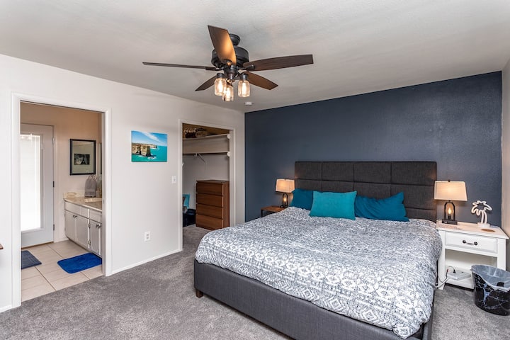 This Master Bedroom gives you easy access to the backyard & pool through the bathroom! PLEASE be sure to read the Airbnb User Manual to understand how to manage the POOL ALARM before entering or exiting the Master Bathroom door.