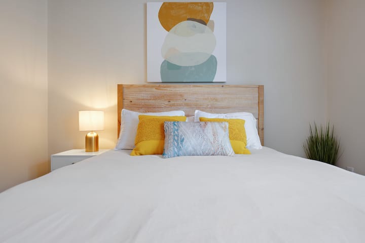 Second bedroom with queen bed. Full bathroom with laundry unit located just outside of bedroom.