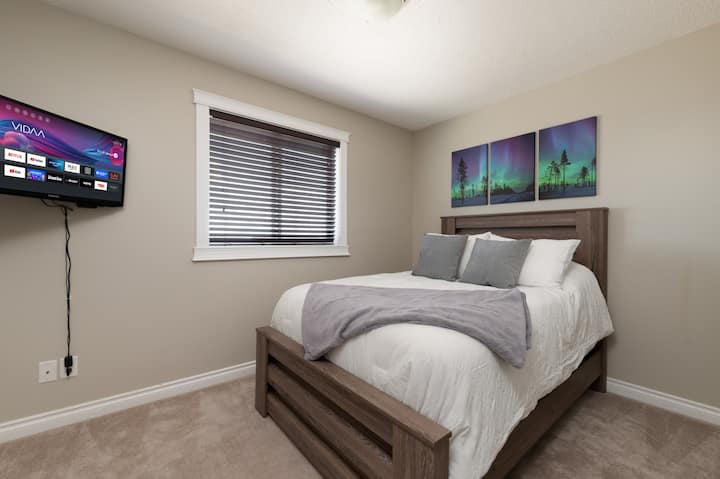 This is one of two bedrooms with comfortable double-sized beds.  All bedrooms also have a smart tv and lamps with USB ports, for your convenience.