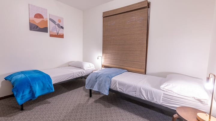 Small bedroom has two narrow twin single beds (30"x75"). Could be put together for to make an RV queen size bed.  Separate a/c units in each bedroom. No TV is this room.