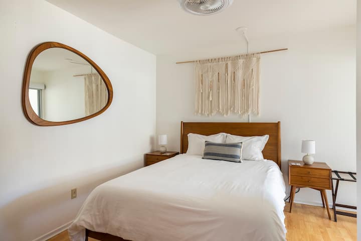 West Elm furnished second bedroom with Casper mattress, each side table has concealed outlets and USB ports, ceiling fan