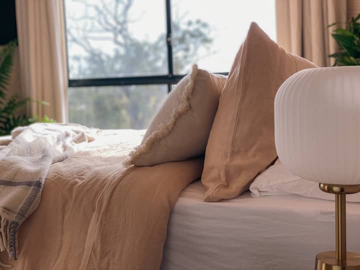 Vintage washed cotton sheets and linen bedding mean you'll want to linger longer here. Linen curtains will close out the view if you fancy a movie from bed or throw them open to see dreamy sunrises and shooting stars falling from inky night skies. 