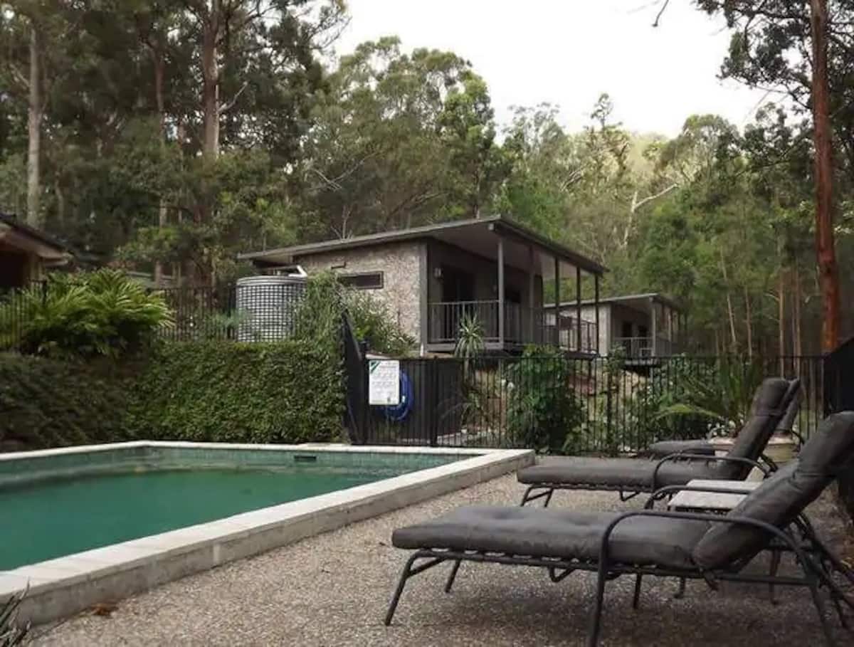 Cabin with private balcony surrounded by nature — photo via the host's Airbnb listing