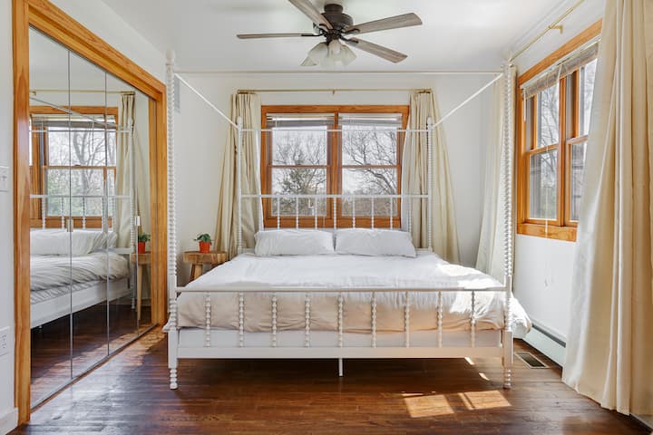 Master bedroom features a canopy, king bed. All windows near the bed have blinds. There is also a secret reading nook in the closet.