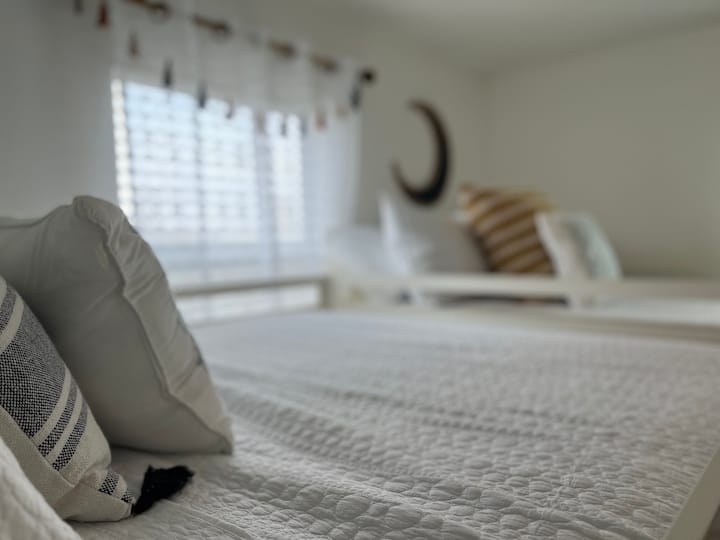 Bunk room is tastefully decorated with 4 double beds. 