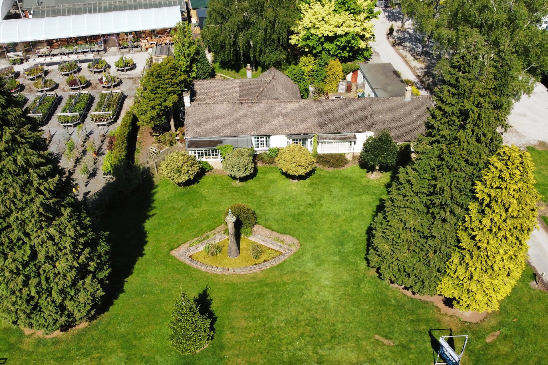 Rolling green hills of the Peak District at golden hour with a charming bungalow in the valley