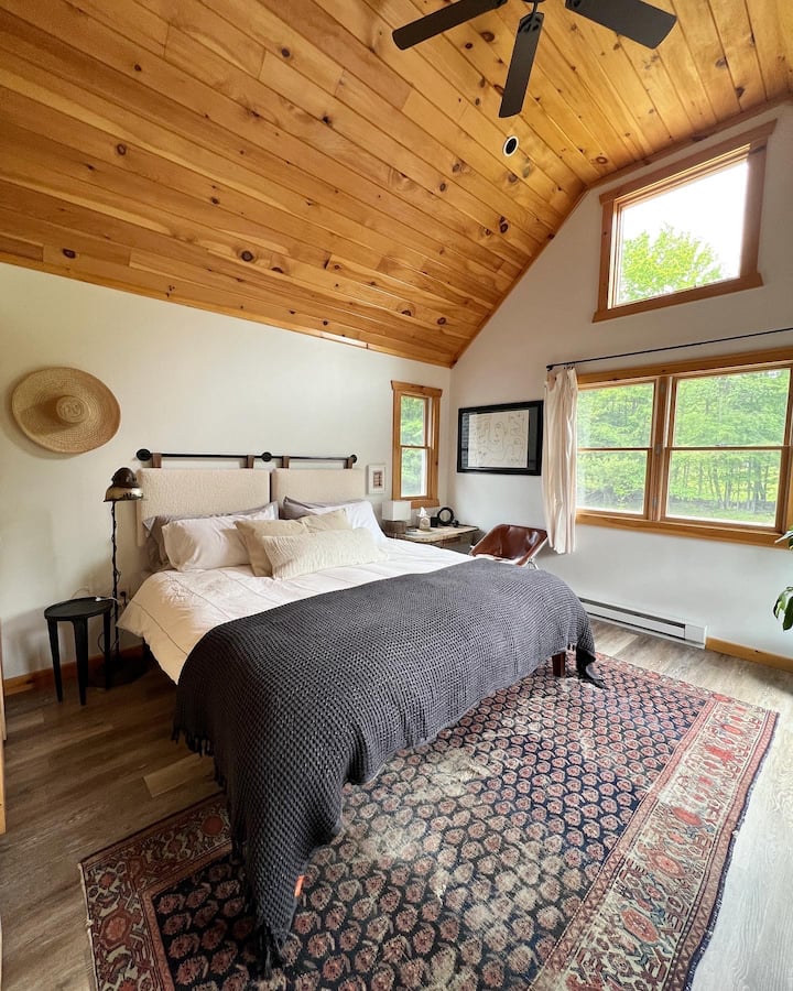 This is master bedroom number two. Each of the upstairs rooms have a king size bed, ample pillows, side tables and lamps, dresser and closet. In addition they have their own private terraces with seating to enjoy the views.