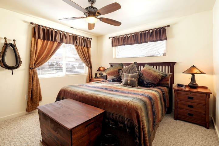 Guest bedroom with king bed, private tv, and views of the Rim. 