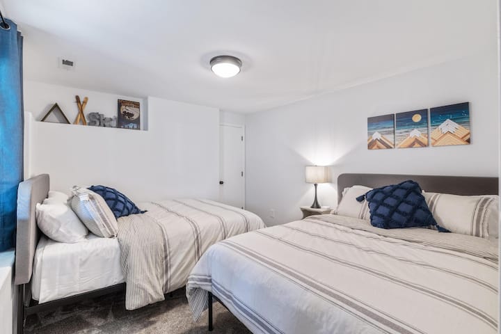 Dream of skiing in our "Ski Room". These two super comfortable queen beds are the perfect place to rest. Enjoy the light that streams in from the window. The vintage galvanized ski sign is a highlight in the room.