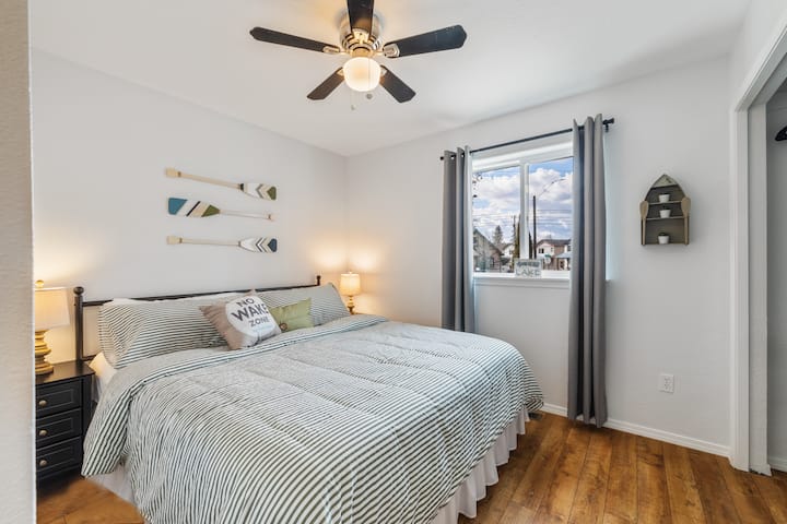 Relax in our super comfy king bed in the "Lake Room". Enjoy the boating decor and inside the closet is a cute vintage dresser with a tv on top. 