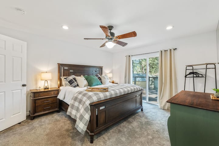 The Owners suite is our favorite space. The king bed is so comfortable and this room has such nice lighting. The dark wood furniture pops against the light carpet and white walls. A touch of dark green brings the outside in. 