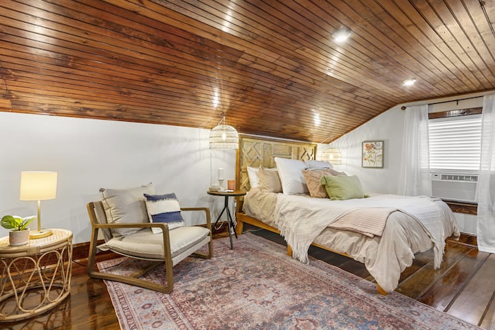 Spacious loft bedroom with king bed and reading nook.