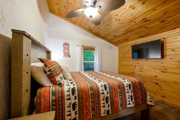 The second bedroom offers a queen bed, Roku TV, dresser, and closet with hangers.