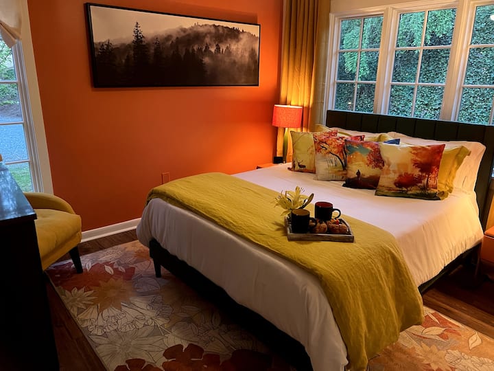 Vibrant guest room with queen bed and comfy linens.